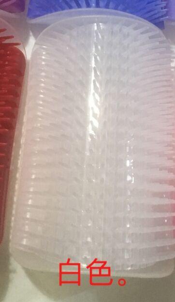 Wall-mounted plastic massager for cats with brush for fur removal and grooming.